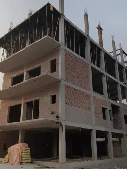 The structural frame of a residential building, showing the progress from the foundation to the upper floors.