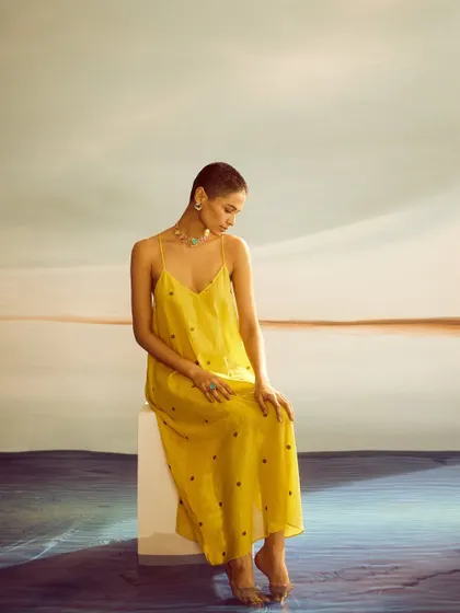 A simple, elegant look with a yellow slip dress. The minimal styling puts the focus entirely on the beautiful statement jewelry from Voyce.