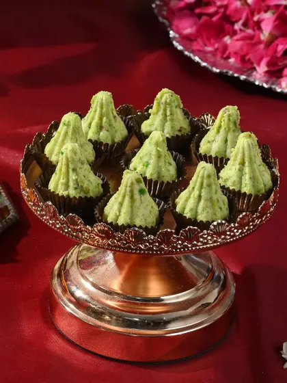 My handcrafted pistachio modaks, presented on an elegant copper stand, are a testament to the blend of heritage flavours and luxury.