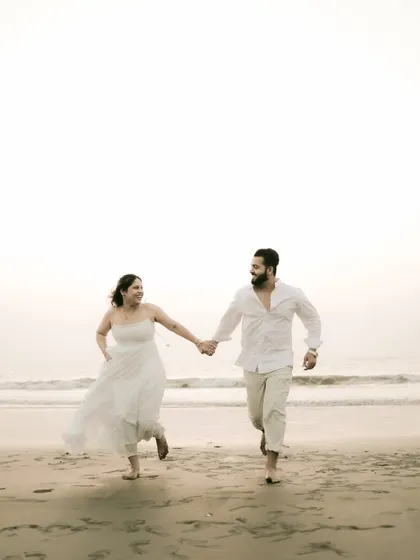 Running freely on the beach, full of joy and energy. This candid action shot brings a sense of fun to the pre-wedding collection.