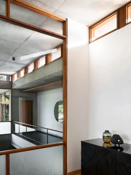Reflections and views across the different levels of the 'House of Canopies'. The design uses glass and open corridors to create visual connections and a sense of a single, unified volume.