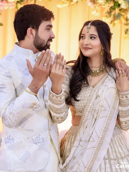 A playful moment between the newly engaged couple as they show off their rings.