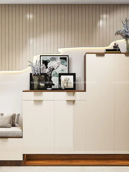 A sleek and modern foyer unit with a stepped design that incorporates seating and storage. The glossy white finish and wooden accents create a clean and contemporary look.