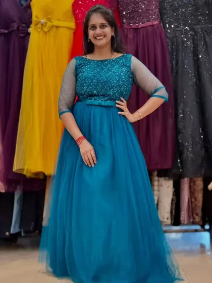 This vibrant teal blue gown is both elegant and fun. The sequined bodice adds sparkle, while the flowing tulle skirt is comfortable enough to dance the night away in.