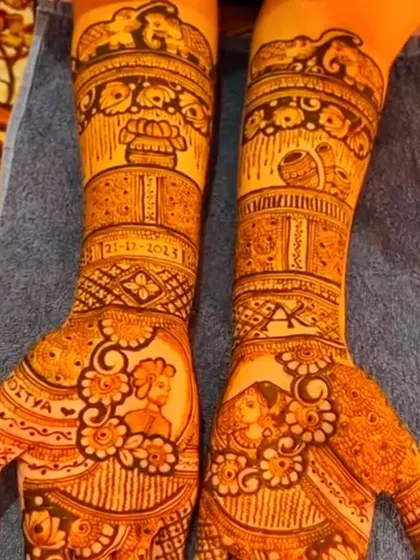 A clear view of a personalized bridal mehndi, showcasing portraits of the bride and groom on each palm, along with their names and wedding date.