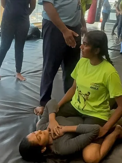 Learning ground survival is crucial. Here, a participant learns how to defend and get up from a bottom position, a vital skill if a confrontation goes to the ground. Our trainers provide close supervision to ensure techniques are learned safely.