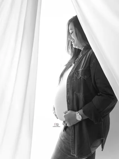 A beautiful, natural light portrait of a mom-to-be. The simplicity of this shot allows her joyful expression and beautiful bump to be the main focus.