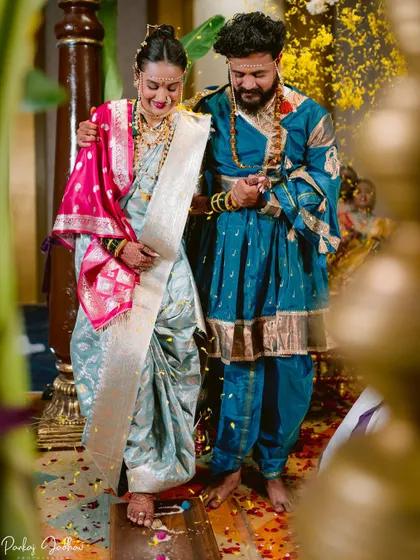 The bride taking her first steps on the grains of rice, a significant ritual in the wedding ceremony.
