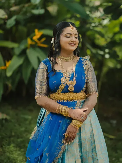 A stunning engagement look for a doctor couple in Mysore. The bride wore a beautiful blue half-saree, and we created a soft, glowing makeup look to complement it.