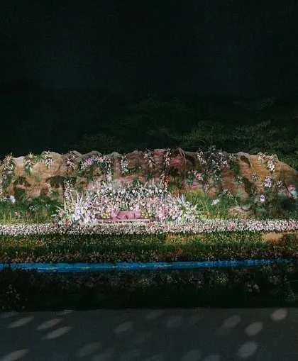 The full view of the reception stage from a distance, emphasizing its magnificent scale and the way it transforms the entire venue into a different world.