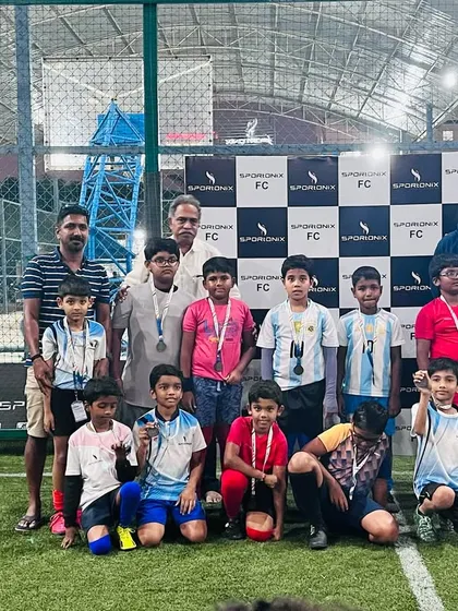 A team of young champions from our football tournament, celebrating their victory with medals.