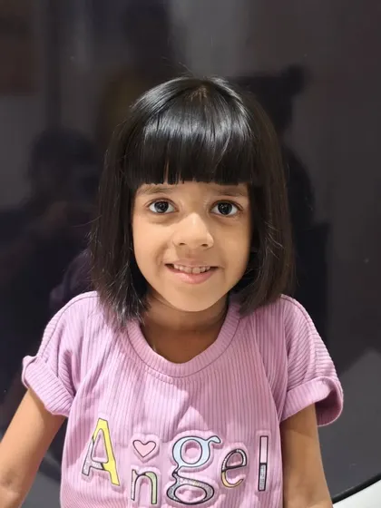A summer chop for this little girl, featuring a chic bob with a fringe.