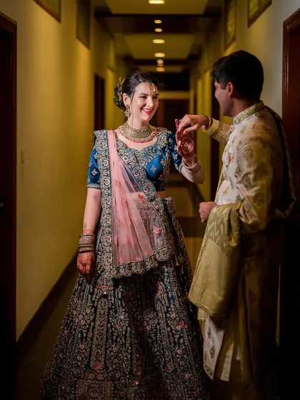 A playful and romantic moment between a cross-cultural couple during their engagement party.
