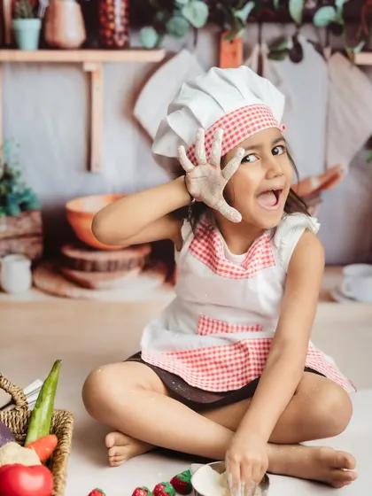 A playful, flour-dusted pose! I encourage kids to be themselves and have fun during our photoshoots.