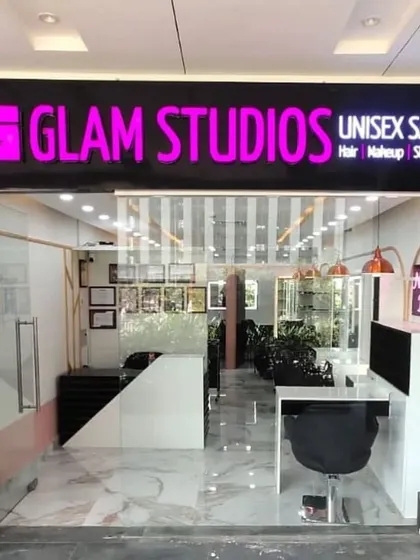 The entrance to our unisex salon at AIPL Business Club. We offer a comprehensive menu of services, from haircuts and color to makeup and nail art, all in one convenient and stylish location.