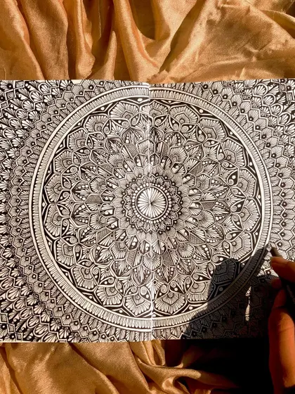 An intricate mandala filling a two page spread in my sketchbook. These early drawings were where I developed my style and passion for detailed patterns.