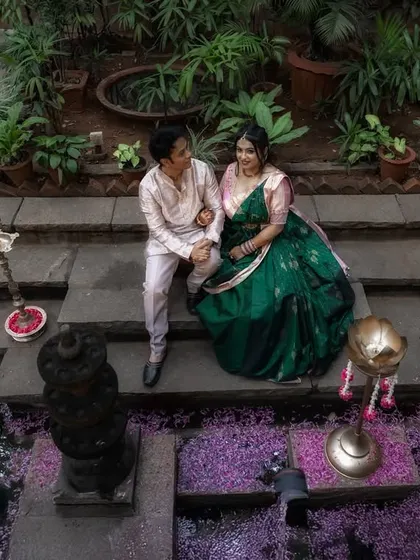 A peaceful moment on the steps of a temple, surrounded by a bed of purple flowers. This setting combines spiritual serenity with natural beauty for a unique pre-wedding photo.
