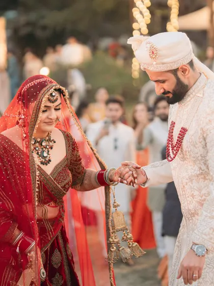 A tender moment as the groom helps his bride down the steps. It's the small gestures of love and support that make a wedding so special.