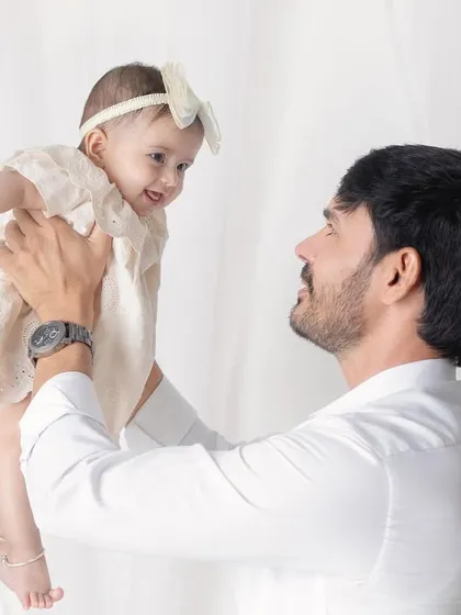A father's love, lifting his daughter up. The joy and trust in her eyes as she looks at her dad is beautiful.