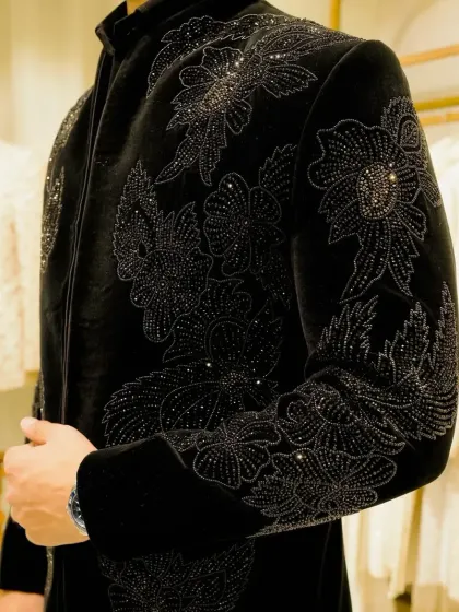 A close-up of the tonal black beadwork, showing the meticulous detail.