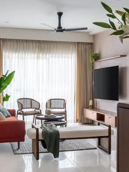A wider view of the 'Living life in colours' living room, showing the comfortable seating arrangement and soft, natural light.
