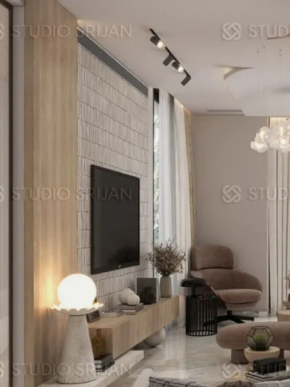 A common area in Greenwood City, Gurgaon, featuring a TV wall with a unique brick-like texture and light wood tones for a warm, contemporary feel.