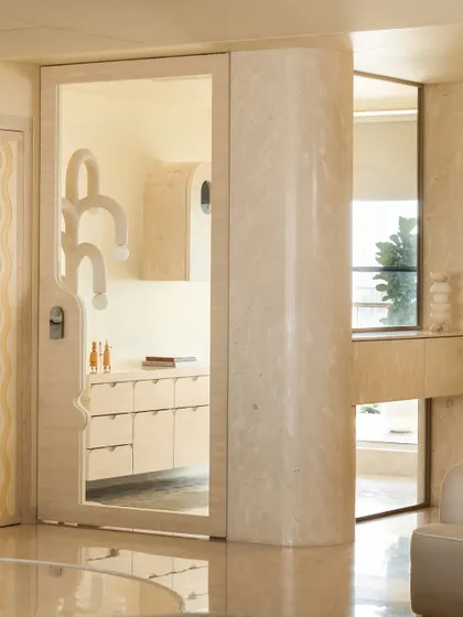 A view of the foyer in Soft Serve, with a custom landing counter featuring a stone-on-stone inlay.