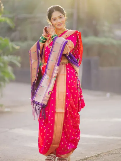The full splendor of the Nauvari saree. This full-length shot showcases the expert draping that creates a graceful and powerful silhouette, perfect for a Maharashtrian bride.