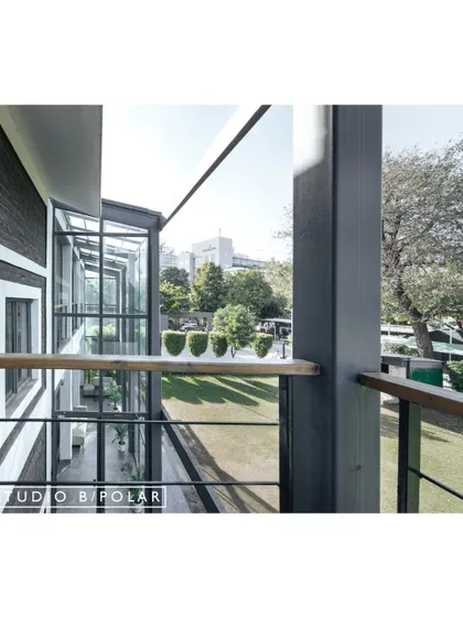 A view from a balcony at the Media Monks campus, looking out over the lawn. We designed multiple points of visual and physical access to the outdoors, integrating the landscape into the daily life of the workplace.