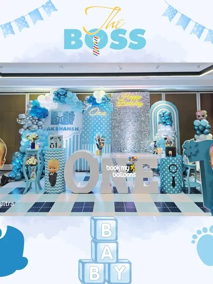 Akshansh, the boss, celebrated his first birthday in style. This large Boss Baby setup featured giant character cutouts, a sparkling silver backdrop, and a cool blue and white color scheme for a corporate-chic party.
