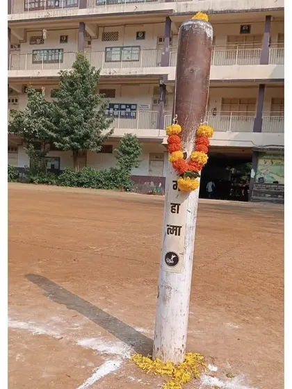 The Kho-Kho pole, decorated with flowers during our Dussehra puja. We treat every part of our sport with reverence.