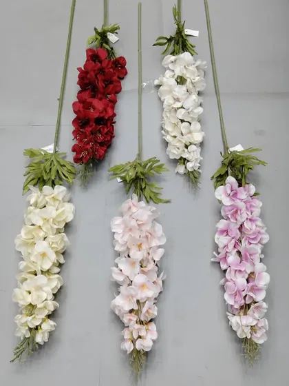 A selection of artificial delphinium or larkspur flower sticks in red, white, cream, and lilac.