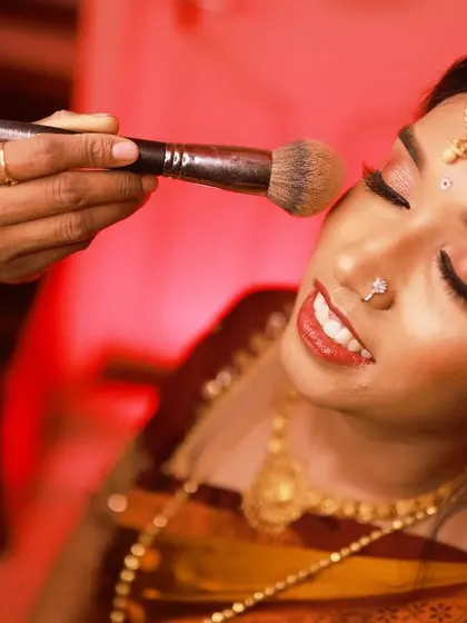A behind-the-scenes moment of me applying finishing powder for Lavanya's engagement look, ensuring it's perfect and long-lasting.