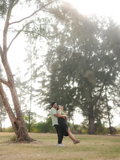 A playful and romantic moment captured in a beautiful, sunlit park. The way he lifts her up feels spontaneous and joyful. This is a perfect example of how I direct couples to interact naturally for authentic photos.