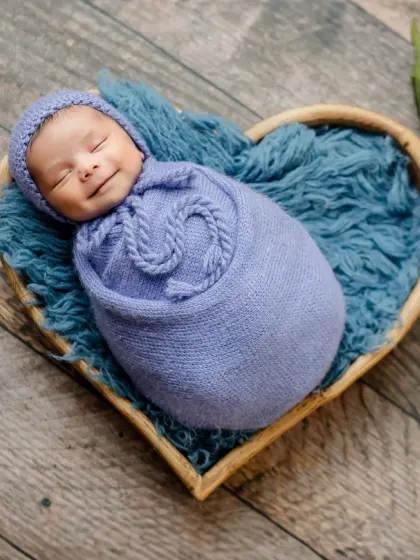 Capturing a newborn's first smile is pure magic. I use careful timing and a comfortable environment in my studio to catch these fleeting, precious expressions.