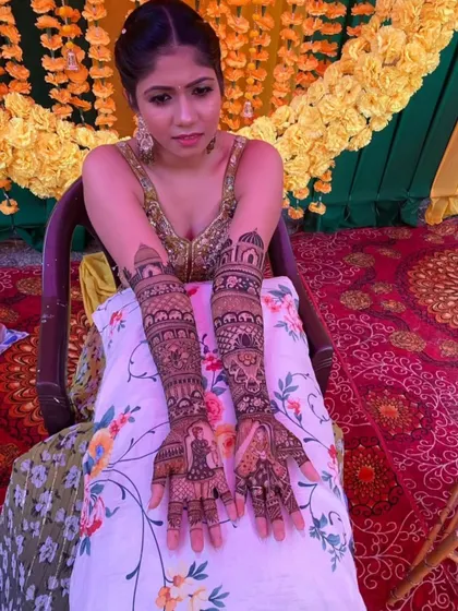 A close-up shot of the bride's hands, highlighting the detailed portrait work and the symmetry of the overall design.