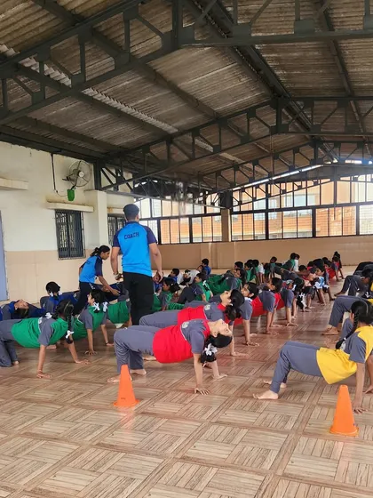 Another angle of our students practicing the reverse tabletop pose. This demonstrates the scale of our wellness programs and the engagement of our young athletes.