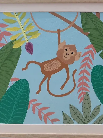A playful monkey hangs from a vine in this custom painting. The cheerful blue background and surrounding jungle leaves make it a fun and engaging piece of art for a child's bedroom or play area.