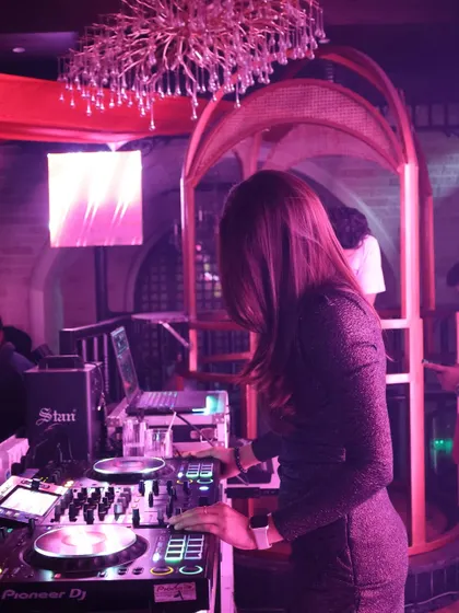 A side profile of me focused on the mixer at Romeo Lane, Dehradun. This shot highlights the technical side of my craft and the intricate work that goes into a set.