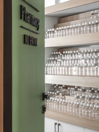 The pharmacy is designed for efficiency and clarity. Open shelving provides doctors with a clear view and easy access to medications, streamlining the process of care.