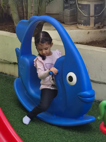 This little Aster is having a great time on the blue fish rocker. Our play equipment is colorful, safe, and designed to spark imagination.