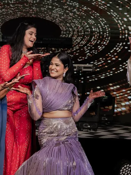 The bride having a fun, candid moment with her friends on stage. My goal is to make sure everyone is having the time of their lives.