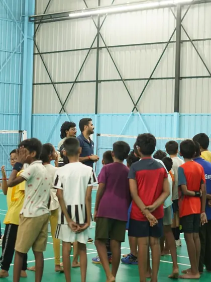 A full view of Coach Aditya Prakash leading a session, sharing his experience and knowledge with the next generation of players.