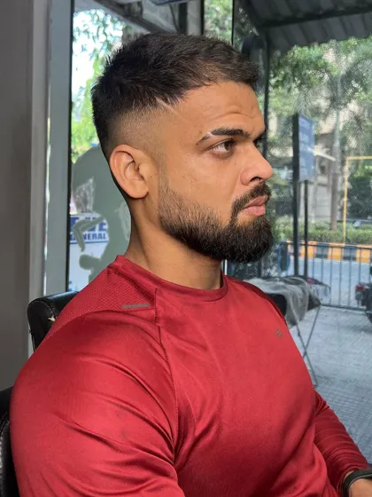 The full view of this Virat Kohli inspired haircut and beard. A sharp look for a cricket fan.