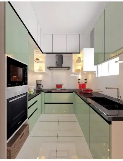 Another view of the light green kitchen, showing the efficient layout with the oven, microwave, and hob all within easy reach.