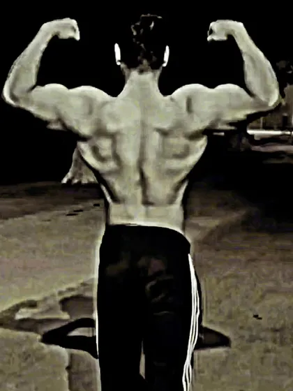 Developing a wide, detailed back is crucial for a powerful physique. This back double biceps pose showcases the development of the lats, traps, and lower back muscles. My programs focus on building both thickness and width for a dominant stage presence.