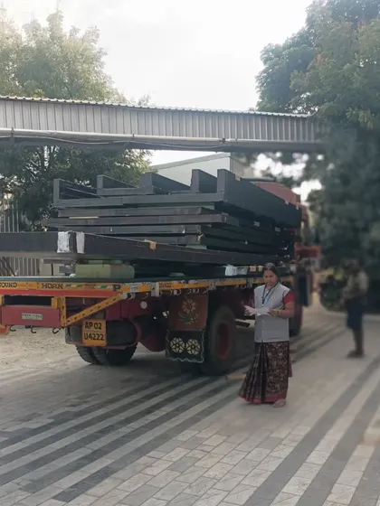 A truck delivering the finished composite panels to the construction site. This prefabrication method minimizes on-site waste and significantly speeds up the project timeline, with this project nearing completion in just 8 months.