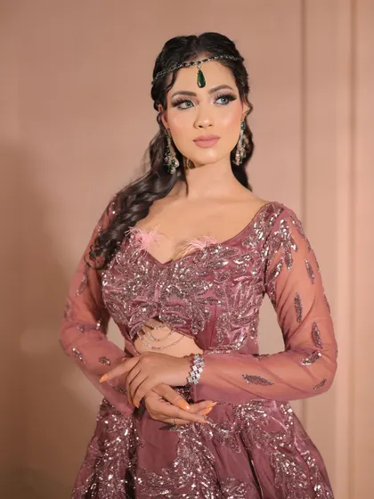 A confident pose showing off the complete party look. The makeup, hair, and outfit all come together to create a cohesive and stunning style.