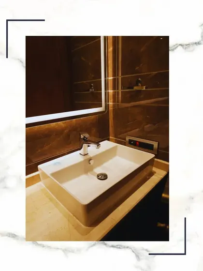 Indulge in the epitome of sophistication. This bathroom features a modern vessel sink, a large mirror, and high-quality fixtures, creating a haven of comfort and extravagance.