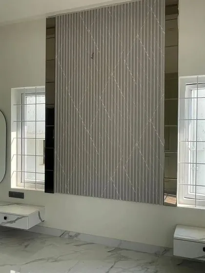This image provides a slightly different perspective of the bedroom feature wall, emphasizing the reflective quality of the tinted mirrors flanking the central panel.